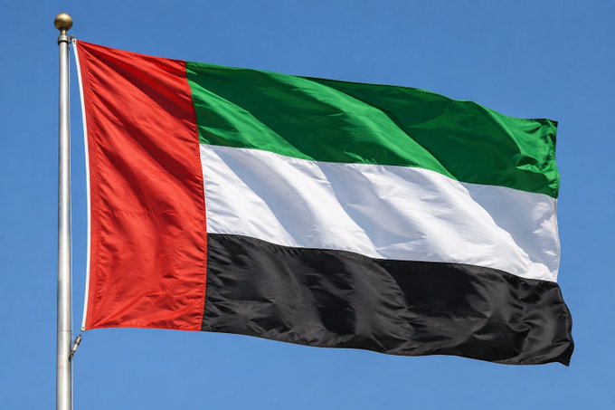 The flag of the United Arab Emirates waves against a clear blue sky, symbolizing the nation as it navigates efforts to maintain its appeal to international investors amid regional tensions.