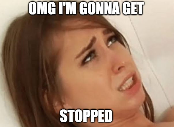 The image shows a close-up of a woman's face with her eyes open, looking up or to the side. The background appears to be a white wall, which contrasts with the woman's brown hair. In the top right corner of the image, there is text that reads "OMG I'm gon na get stopped".