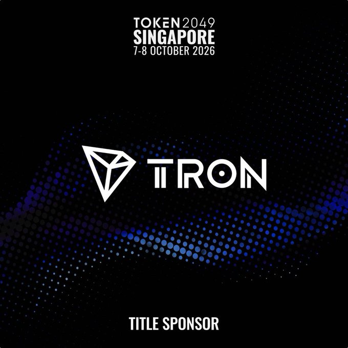 A promotional graphic for "TOKEN 2049 SINGAPORE" taking place on "7-8 OCTOBER 2026", featuring the TRON logo and text indicating they are the "TITLE SOCKS"