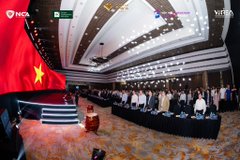 A conference hall filled with attendees seated at tables, with a large Vietnamese flag displayed on the left side, captures the opening day of the Vietnam RWA Summit 2026—an international conference on real-world asset tokenization bringing together over 50 speakers and nearly 100 organizations.