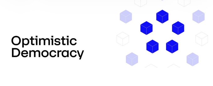The image displays the "Optimistic Democracy" logo on the left, accompanied by a graphic of blue cubes on the right. The accompanying post discusses the vulnerability of centralized authority in democratic governance, comparing ancient Athenian judicial corruption to modern systems—a theme that aligns with the brand's focus on building more resilient, decentralized democratic processes through technology.