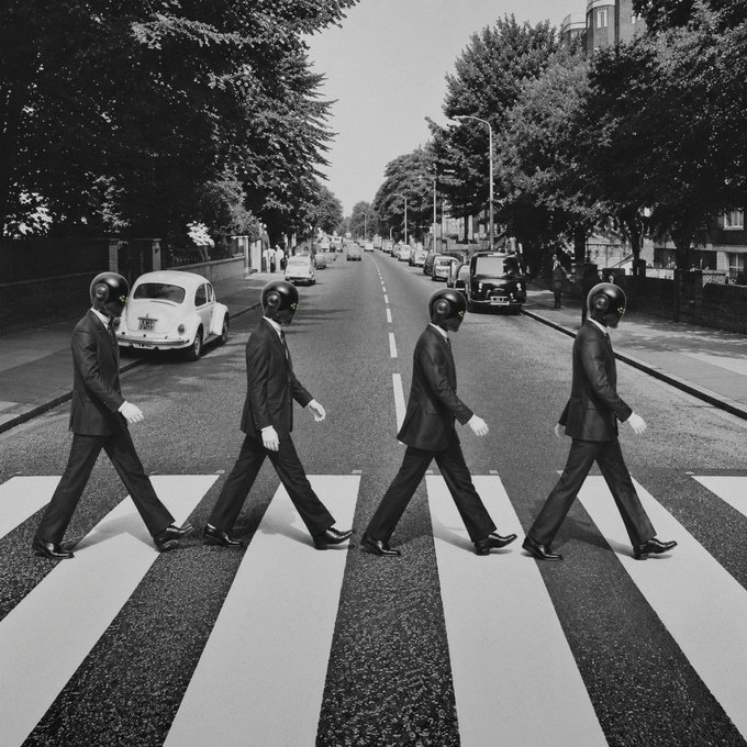 Four men in suits with dark helmets stride in unison across a zebra crossing, echoing The Beatles' iconic Abbey Road photo, visually illustrating the post's message that the path is paved for AI agents to follow.