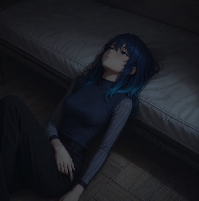 An anime-style girl with long dark blue hair with light blue tips lies on a dark floor beside a gray sofa, looking upward in a dimly lit room.