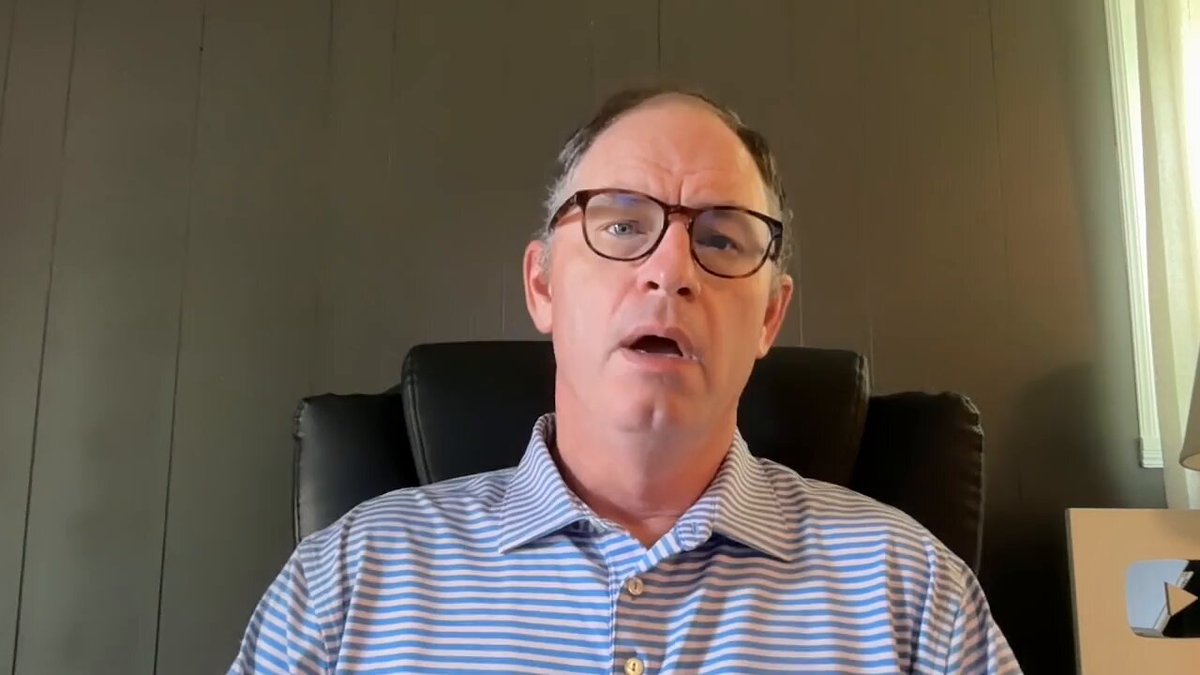 The image shows a man wearing glasses sitting in an office chair, looking at the camera with a serious expression. There are no other people or objects visible in the frame. The caption of the image reads "NEW Rumors Of Ripple Buying Circle Watch The Full Youtube Video Here: youtu.be/JgsDfMxwJ6g". This suggests that there might be some new information about Ripple buying circle, and it is being shared on a video platform like YouTube.