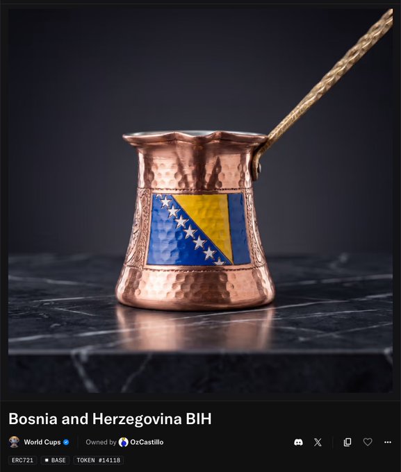 The image features a copper-colored coffee cup with a blue and yellow design, placed on top of a marble countertop. The cup has a handle sticking out from its side, suggesting that it's ready for use. The background of the image is black, which makes the colors of the cup stand out even more. In the corner of the image, there are some text elements such as "Bosnia and Herzegovina Bih" and "World Cup Opensea.io".