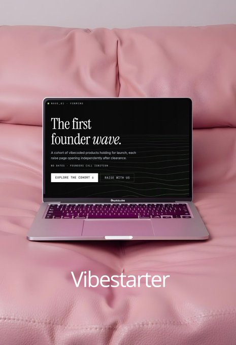 A MacBook laptop sitting on pink leather cushions displaying a 'Vibestarter' landing page with the headline 'The first founder wave.' promoting a cohort of vibecoded products.