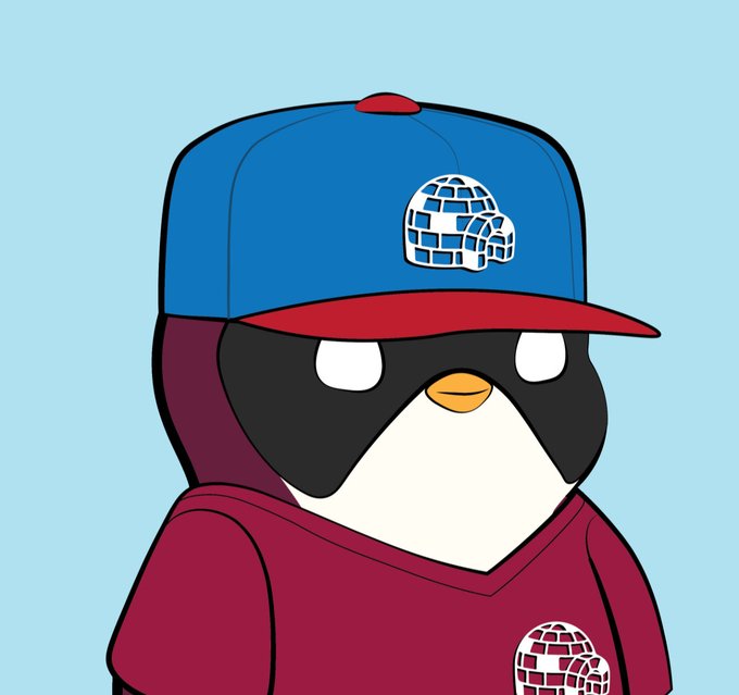 A cartoon penguin character wearing a blue and red baseball cap and a maroon shirt, both featuring an igloo logo, set against a light blue background.