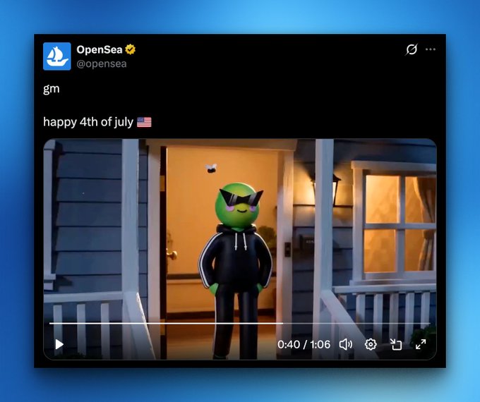 A screenshot of a tweet from @opensea saying "gm" and "happy 4th of july 🇺🇸," featuring a video thumbnail of a green cartoon character wearing sunglasses and a black hoodie standing on a porch at 0:40/1:06, which the post notes showcases the SpaceRidersXYZ NFT character.