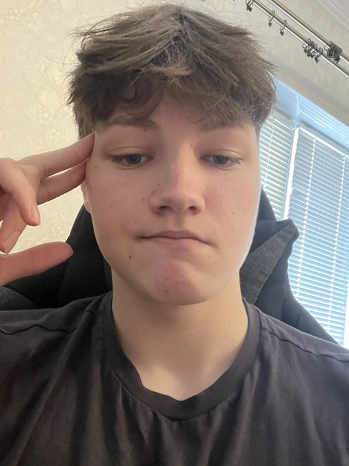 A young person with short brown hair poses with a serious, contemplative expression, resting their fingers against their temple as if deep in thought. The selfie visually reinforces the caption's theme of "many hours of thinking," while the unchanged 24h price (0%) underscores the stubborn commitment to bull-posting $PENGU.
