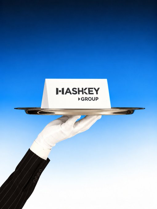 A butler's gloved hand holds a silver tray with a place card reading 'HASHKEY GROUP' against a blue gradient background.
