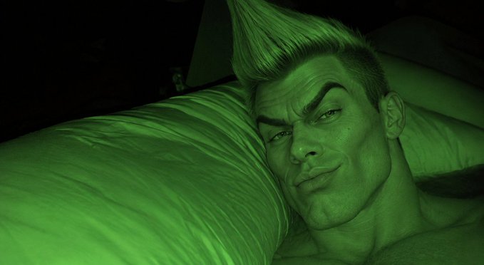 A green-skinned man with a sharp, spiky hairstyle rests his head on a pillow, gazing at the camera with a slight smirk. The image, paired with the post "Soon...", suggests a teasing preview of the character's impending appearance or comeback.