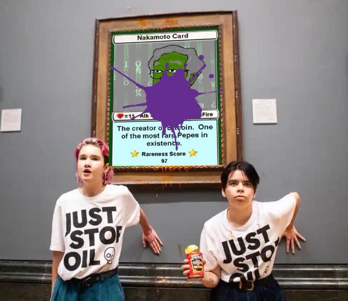 Two people posing in front of a framed digital artwork labeled 'Nakamoto Card' that depicts Pepe, wearing white t-shirts that say 'JUST STOP OIL'.