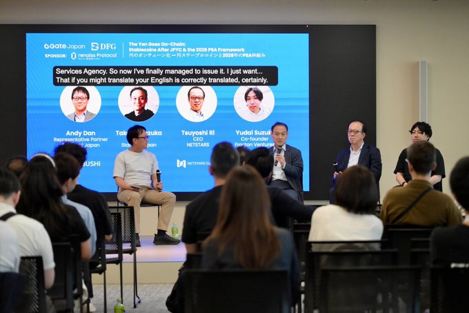 Panel discussion on "The Yen Goes On-Chain: Stablecoins After JPYC & the 2026 PSA Framework" featuring Andy Dan (Representative Partner), Taka Tezuka (CEO), Tsuyoshi Ri (Netstars), and Yudoi Suzuki (Co-founder), addressing a seated audience at the event.