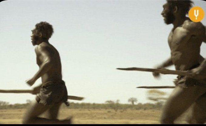 Two shirtless men running frantically with spears across a dry landscape. This mirrors the poster's panicked urgency as they chased the $TIA airdrop only to be left empty-handed and burned by a crashing token.