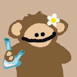 A cartoon illustration of a smiling brown monkey with a white flower on its ear, holding a blue slingshot.