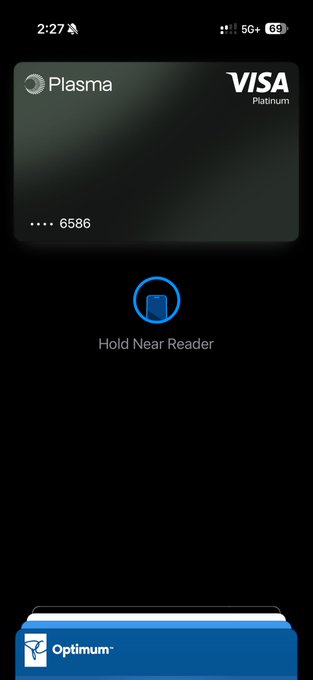 The image shows a phone screen displaying a Visa payment app with a credit card reader icon next to a Visa card. The app also has an option for users to hold near their wallet's nearest reader.