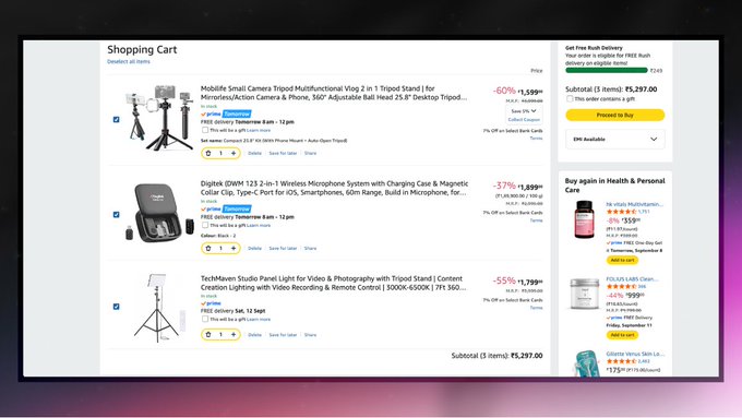 A screenshot of an Amazon shopping cart page showing items including a tripod stand, Digitek wireless microphone system, and TechMaven Studio panel light, with a subtotal of ₹5,297.00.