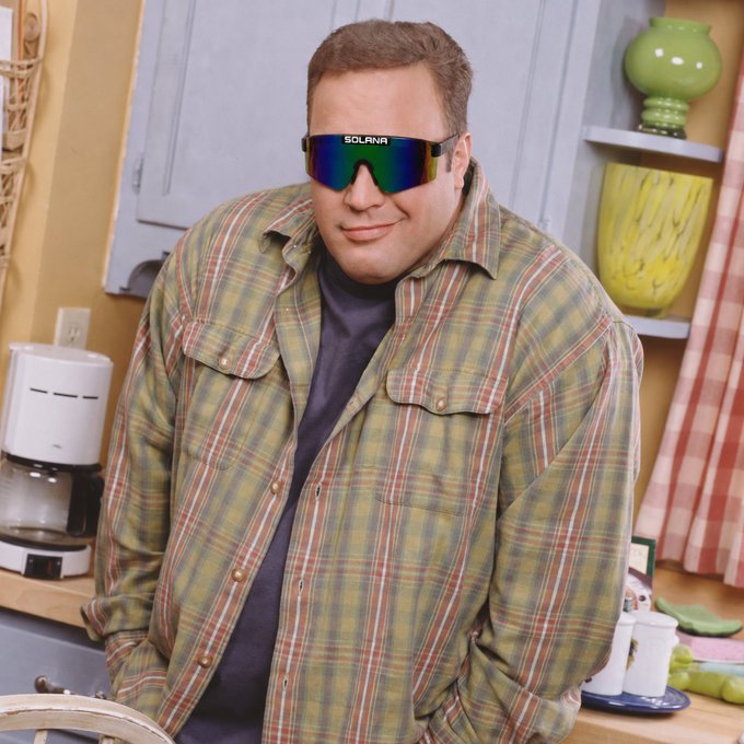 An edited photo of a man in a plaid shirt wearing large sunglasses labeled 'SOLANA'.