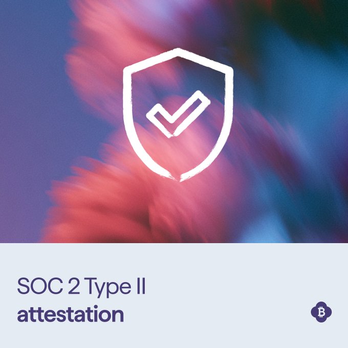 A graphic displaying a white shield with a checkmark over a colorful gradient background, with text reading 'SOC 2 Type II attestation' and a Bitcoin logo.