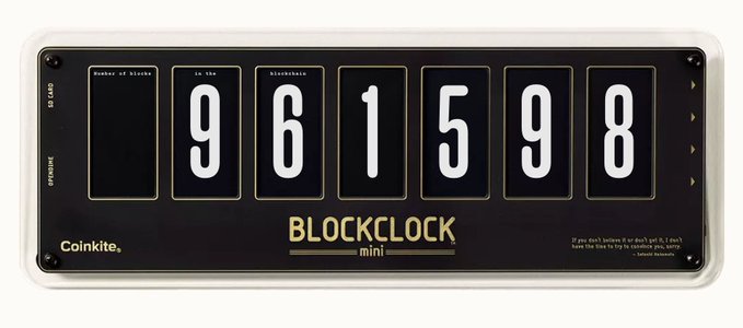 A 'Coinkite BLOCKCLOCK mini' displays the number '961598' across its mechanical number wheels.