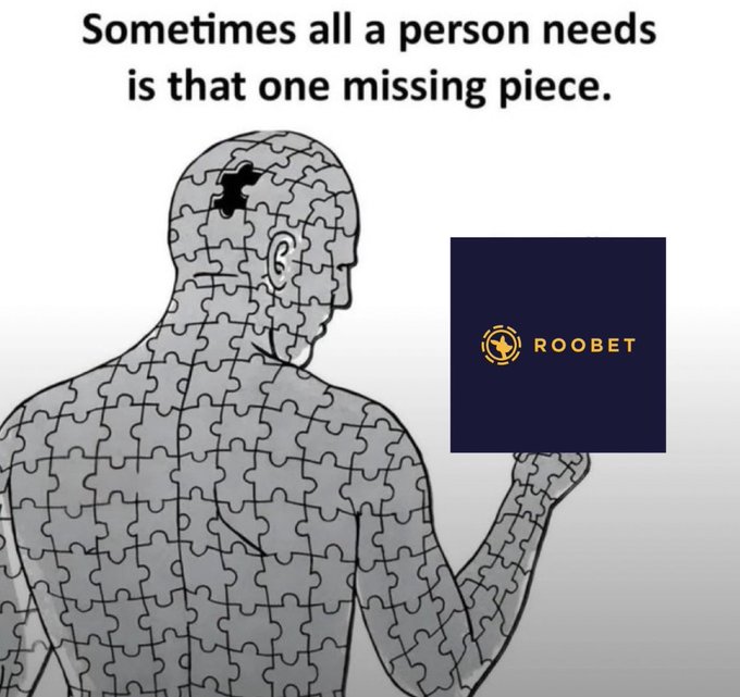 An illustration of a human figure made of puzzle pieces holding a dark blue puzzle piece featuring the 'ROOBET' logo, with the text 'Sometimes all a person needs is that one missing piece.'