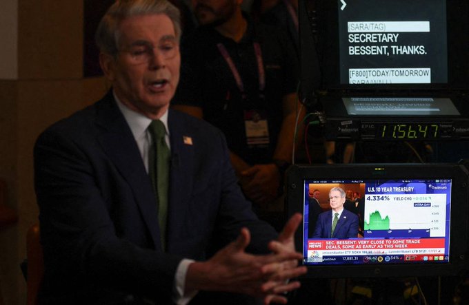 A man in a dark suit and green tie being interviewed, with a CNBC monitor beside him showing "SEC BESSENT" and "U.S. 10 YEAR TREASURY 4.334% YIELD CMS +0.0018," with a teleprompter displaying "SECRETARY BESSENT, THANKS" and S&P data showing 11,564.7.