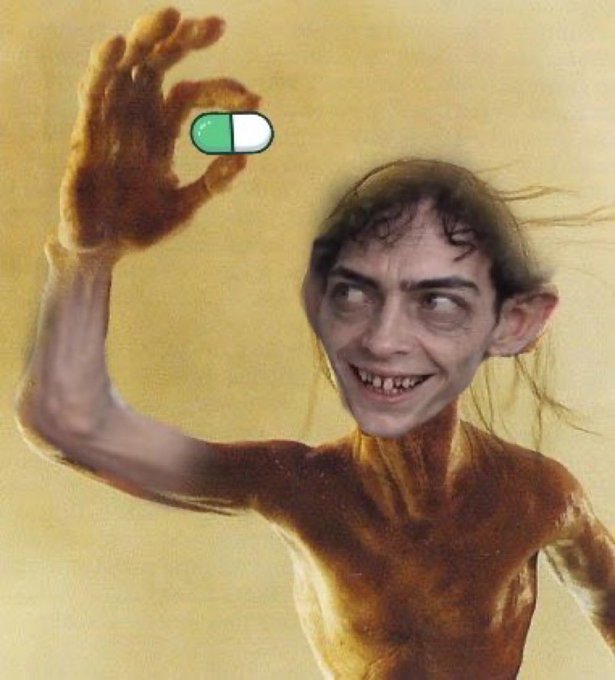A digitally altered image of Gollum from Lord of the Rings smiling creepily while holding up a pill that is half green and half white.