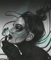 A moody profile shot of a person with elaborate makeup, styled hair, and dark clothing against a shadowed background.