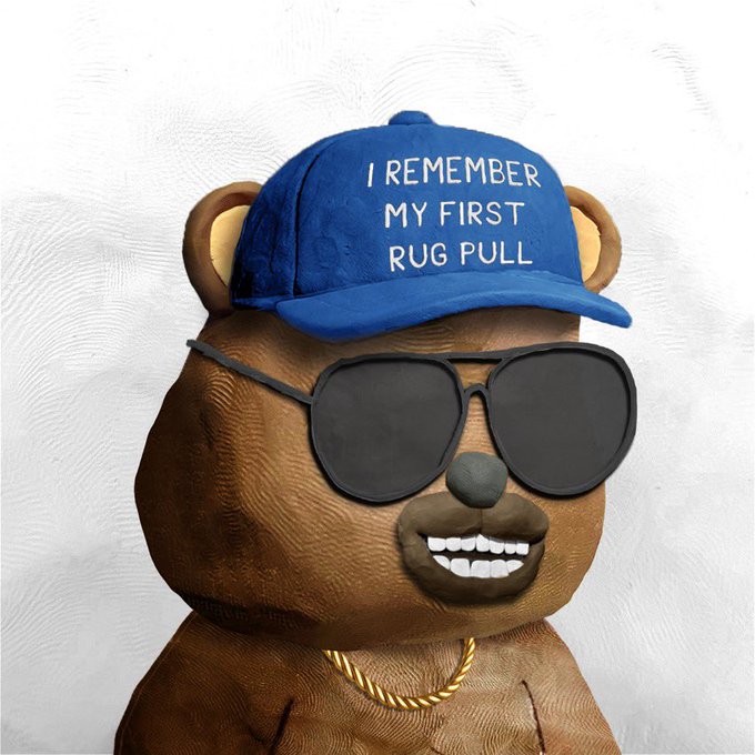 A 3D-rendered brown bear wearing aviator sunglasses, a gold chain, and a blue cap reading "I REMEMBER MY FIRST RUG PULL" smiles against a white background.