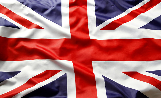 A close-up image of the United Kingdom's Union Jack flag waving with visible folds and creases in the fabric.