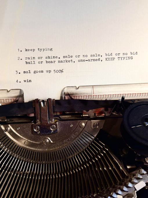 A vintage typewriter with typed text reading '1. keep typing, 2. rain or shine, sale or no sale, bid or no bid, bull or bear market, one-armed, KEEP TYPING, 3. sol goes up 500%, 4. win'.