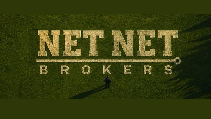 An aerial view shows the text 'NET NET BROKERS' painted in gold on a green grass field, with a man in a suit standing in front of it.
