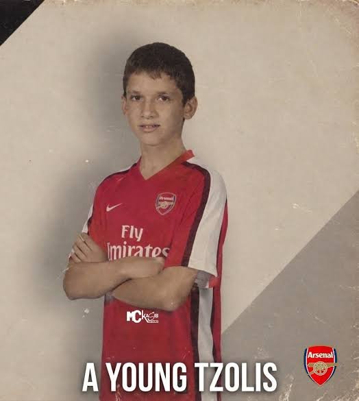 A childhood photo of a young boy wearing an Arsenal 'Fly Emirates' jersey, captioned 'A YOUNG TZOLIS' with the Arsenal club badge.