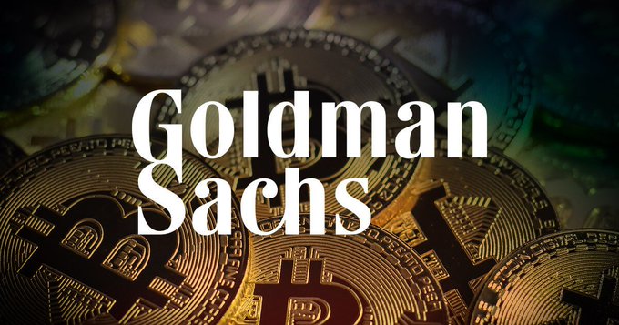 A promotional graphic showing physical Bitcoin tokens with the text 'Goldman Sachs' overlaid in large white serif font.