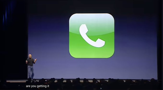 Steve Jobs stands on a presentation stage in front of a giant green phone icon with the subtitle 'are you getting it'.