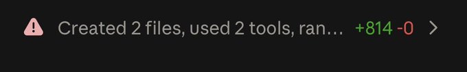 A dark notification banner with a warning icon reads 'Created 2 files, used 2 tools, ran... +814 -0'.