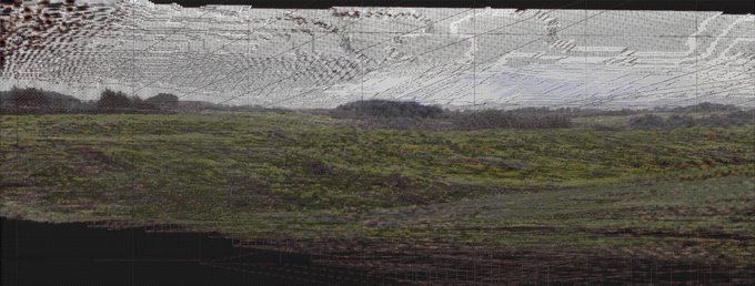 A wireframe mesh of rolling green hills and distant mountains stretches across the frame, revealing the underlying generative geometry of the landscape. The exposed polygonal structure reflects the traditional procedural construction process described, where the terrain is built up mathematically before color and texture are applied.