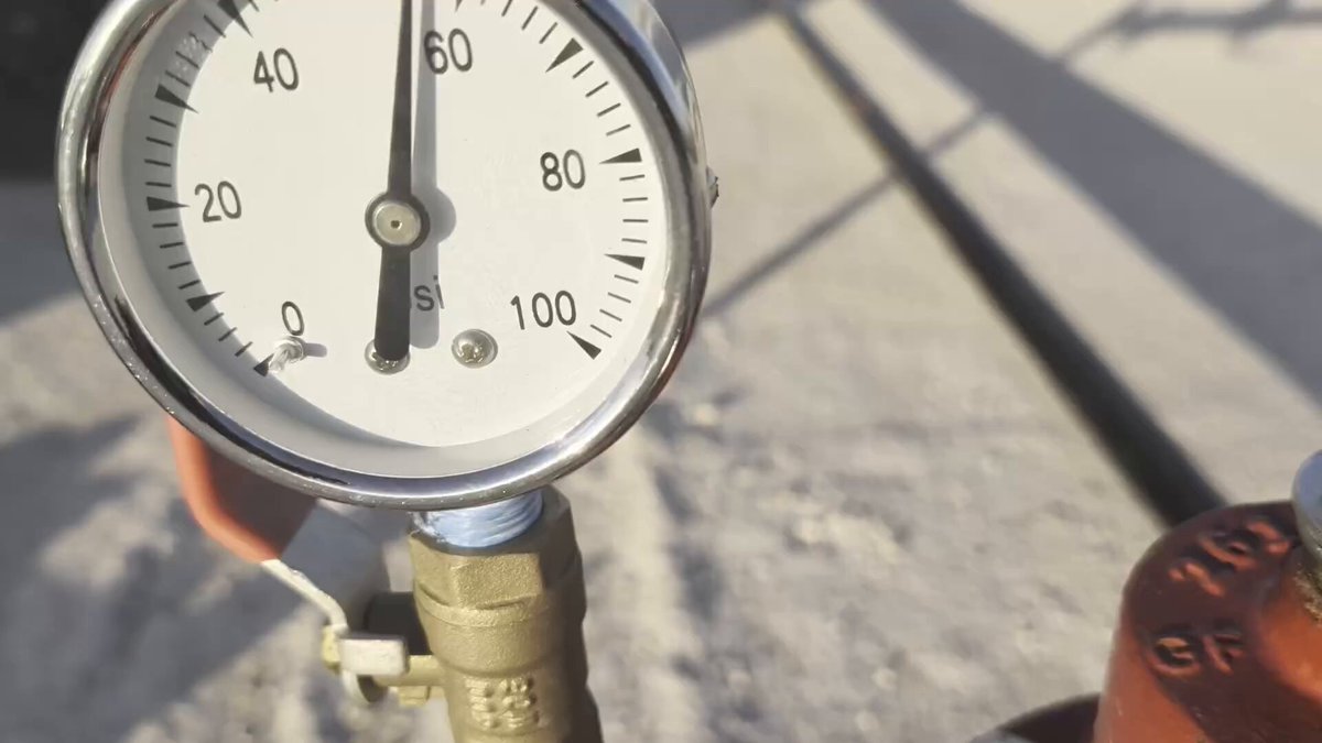 The image shows a gauge with the number "1" on it, indicating that there are five more units needed before reaching the desired level or value. The gauge appears to be part of a larger system, as indicated by the presence of a red pipe in the background.