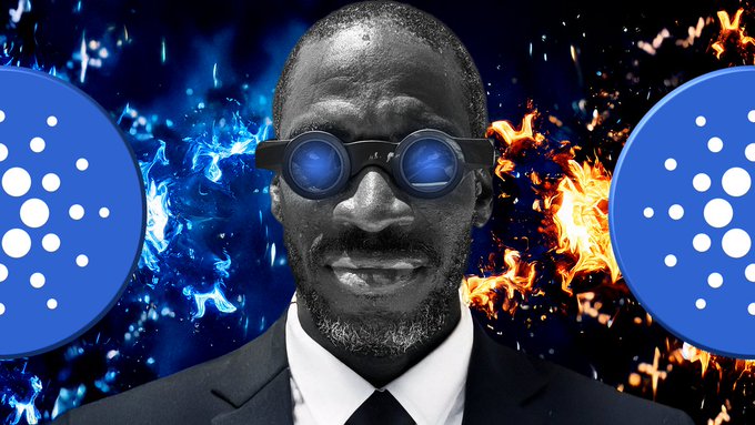 A man in a suit and tie wearing blue-tinted sunglasses is centered against a dramatic background of blue and orange flames, flanked by two blue Cardano (ADA) logos on either side, visually tying the "gm Cardano smart contracts" message to the blockchain project's iconic branding.