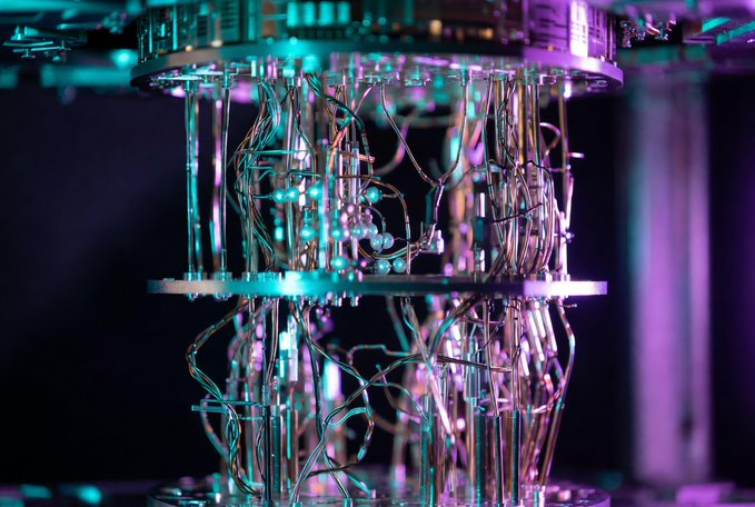 A close-up of an intricate mechanical or quantum device with glowing teal and purple lights illuminating a complex web of copper wires and metal components.