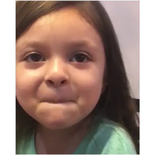 A close-up of a young girl with dark hair making an emotional, teary-eyed pouty face.