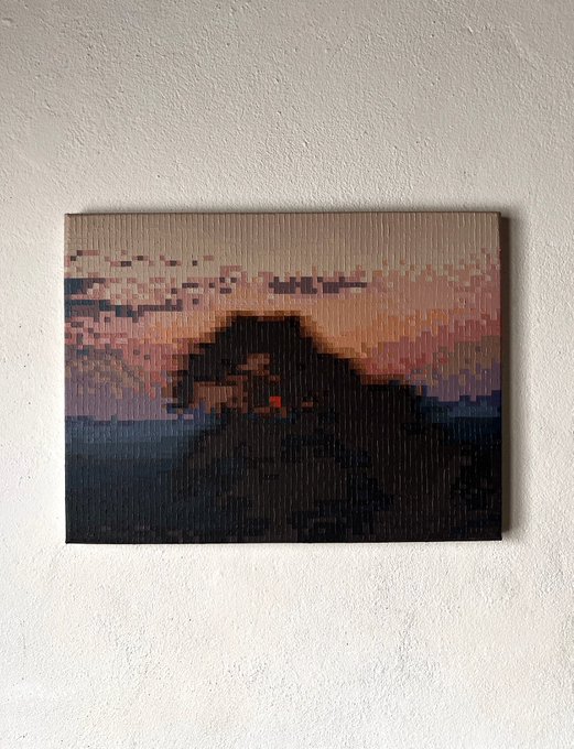 A small canvas artwork mounted on a textured white wall, depicting a pixelated/lo-fi sunset landscape with mountains in warm pink and orange tones