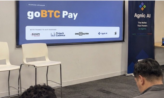 A presentation screen displays "goBTC Pay" as a Diamond Sponsor alongside sponsor logos including Elevate, Fintech Cadence, and OneEleven, with an "Agnic AI" banner promoting "The Wallet That Powers AI Agents." The setup directly illustrates the post's discussion, as the event appears to showcase how platforms like goBTC Pay are enabling native Bitcoin payments for autonomous AI agents to transact for digital services.