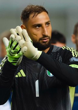 A soccer goalkeeper with a beard, wearing a black jersey with the number 1 and Adidas branding, gestures with his gloved hands. The image appears to relate to a high-stakes sports prediction market bet on Turkey's match against Italy, though no specific text or numbers are visible in the photo itself.
