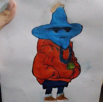 A child's crayon drawing on paper depicts a blue star-headed character wearing a red hoodie, sunglasses, and a gold chain.