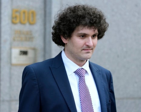 Sam Bankman-Fried, founder of FTX, is seen in a dark navy suit and pink striped tie as he exits a building marked "500," reportedly the U.S. Courthouse in Lower Manhattan. The image relates to his recent appeal to the U.S. Supreme Court to overturn his 2023 fraud conviction and 25-year prison sentence.