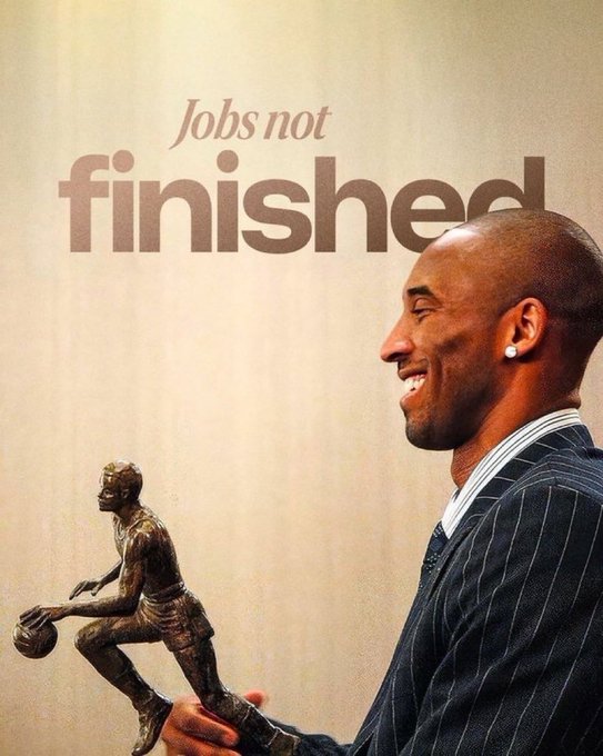 A tribute image showing Kobe Bryant smiling in a pinstripe suit while holding a bronze statue of himself, with the text 'Jobs not finished' above.