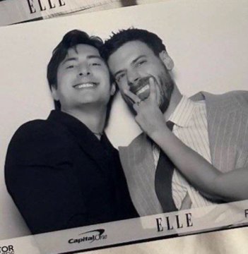 A black-and-white photo from an ELLE magazine spread shows Ben Affleck and a young Asian man smiling warmly as Affleck touches his face.