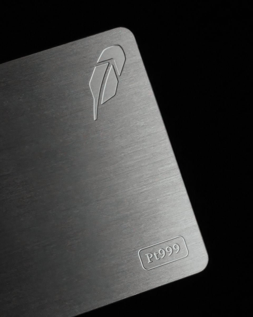 A brushed platinum card with an engraved logo and 'Pt999' marking, indicating its high platinum purity.