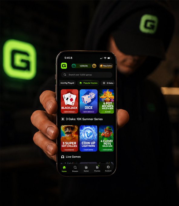 A person holds a smartphone displaying a gaming app interface with categories like 'Blackjack,' 'Dice,' and '4 Hot Richies,' with green 'G' logos in the background.